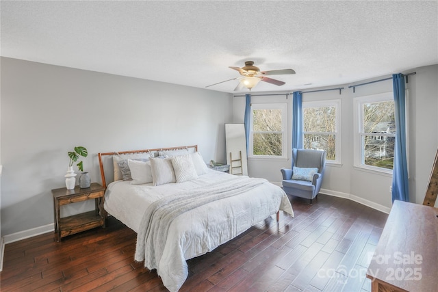 bedroom featuring ceiling fan, dark hardwood / wood-style flooring, and a textured ceiling