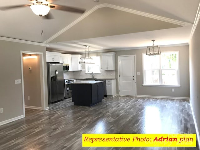 kitchen featuring white cabinetry, a center island, vaulted ceiling, pendant lighting, and appliances with stainless steel finishes