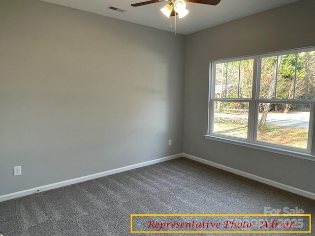 spare room featuring ceiling fan and carpet