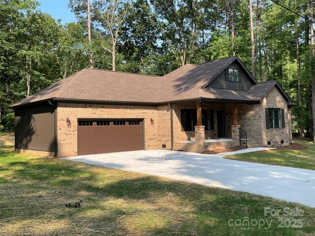 305 General As Johnston St, Stanley, NC 28164 - view of front of property featuring covered porch, an attached garage, brick siding, and driveway