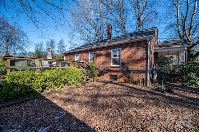 back of property featuring a wooden deck