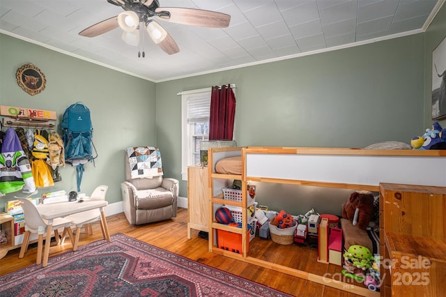 bedroom featuring ornamental molding, ceiling fan, and wood-type flooring