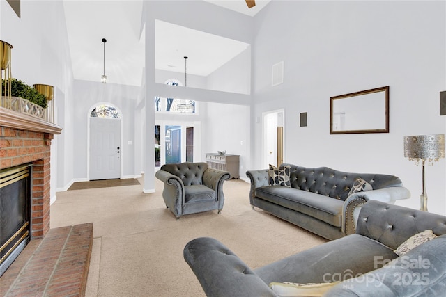 living room featuring a towering ceiling and a fireplace