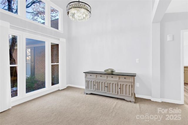 interior space with a towering ceiling and a notable chandelier