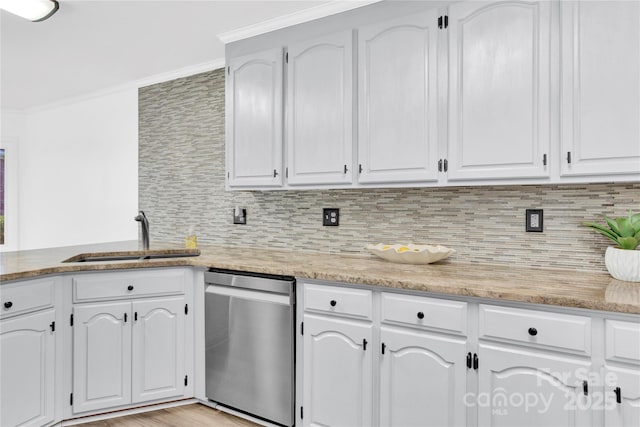 kitchen with white cabinets, stainless steel dishwasher, backsplash, and sink