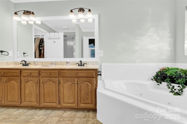 bathroom featuring tiled bath and vanity