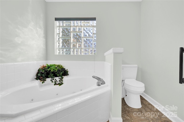 bathroom with toilet, tile patterned floors, and tiled tub