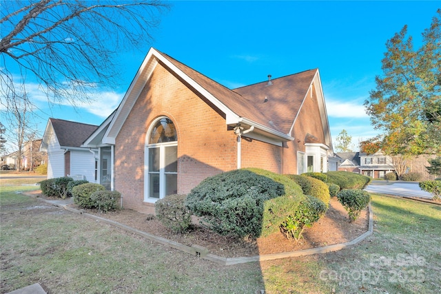 view of side of home featuring a yard