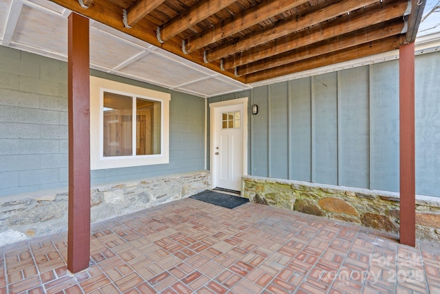 view of exterior entry with a patio area