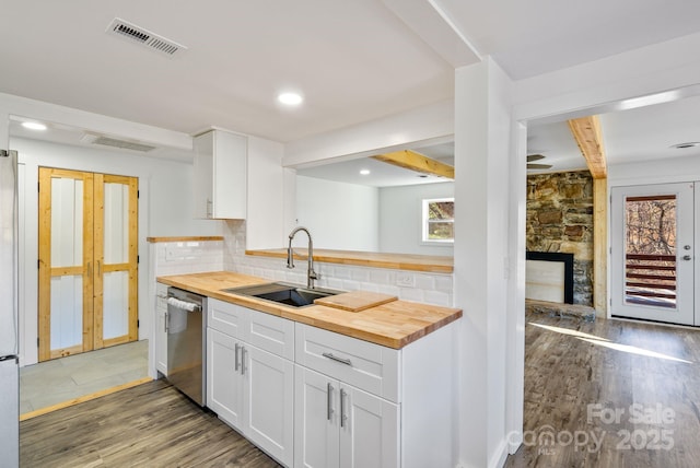 kitchen with white cabinets, wooden counters, dark hardwood / wood-style flooring, tasteful backsplash, and sink