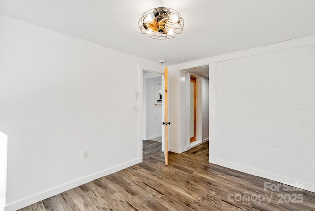 spare room featuring wood-type flooring