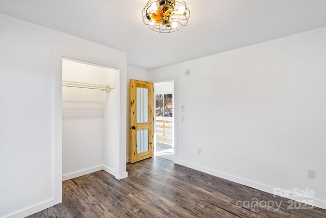 unfurnished bedroom featuring a closet and dark wood-type flooring