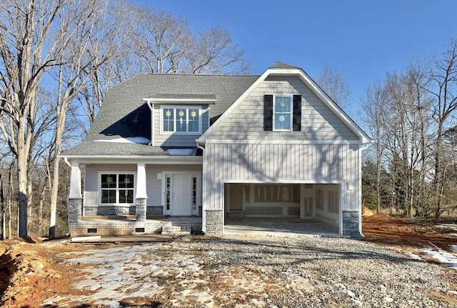 view of front of property featuring covered porch and a garage