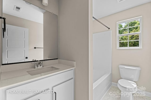 bathroom featuring toilet, shower / bath combination, vanity, visible vents, and baseboards