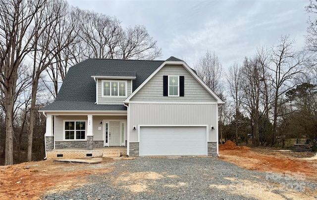 view of front of property with stone siding, roof with shingles, an attached garage, and driveway