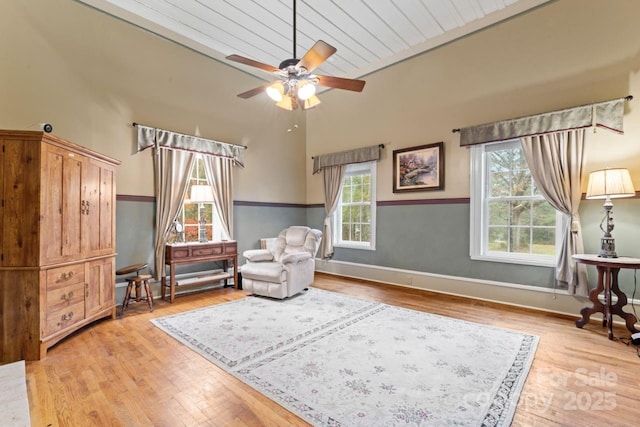 sitting room featuring ceiling fan, light hardwood / wood-style flooring, and plenty of natural light