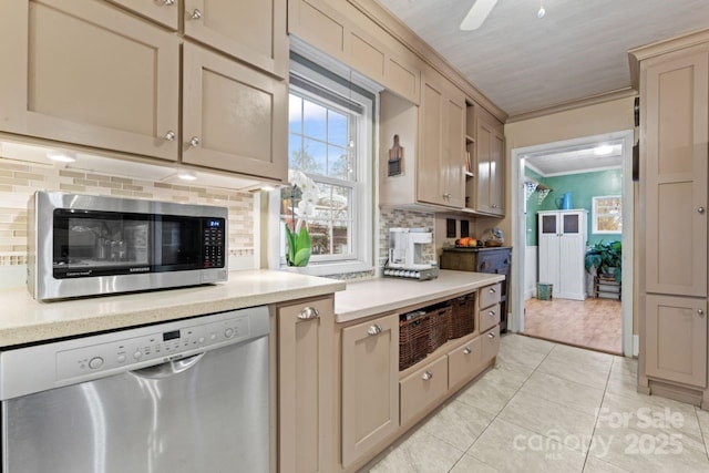 kitchen featuring stainless steel appliances, crown molding, decorative backsplash, and light tile patterned floors