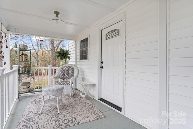 view of exterior entry with covered porch and ceiling fan