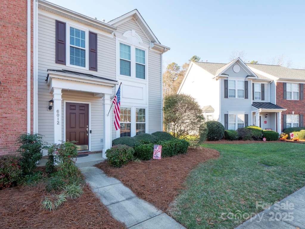 view of property featuring a front lawn