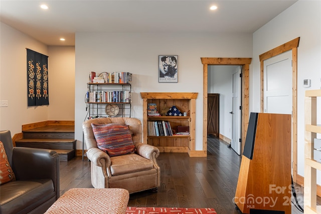 living room featuring baseboards, hardwood / wood-style flooring, and recessed lighting