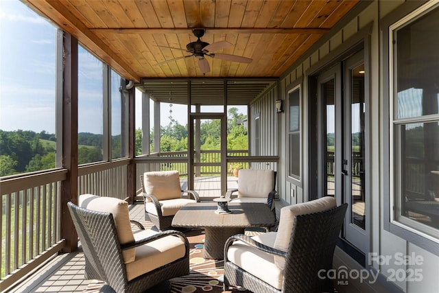 sunroom with wooden ceiling and ceiling fan