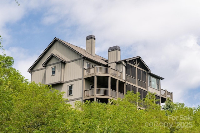 back of property with a chimney