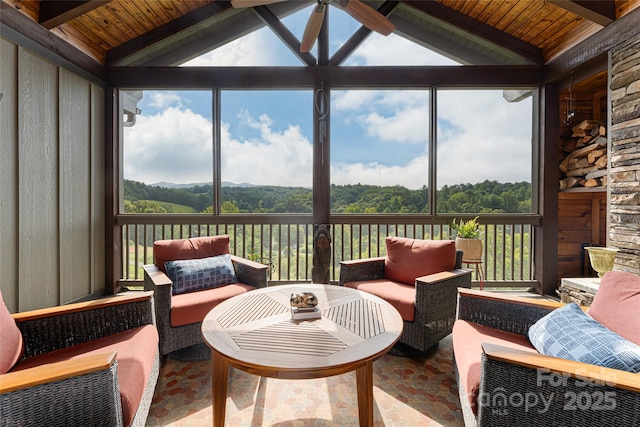 sunroom with vaulted ceiling with beams, wood ceiling, and a ceiling fan