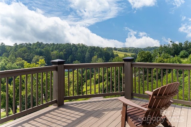 wooden deck featuring a view of trees