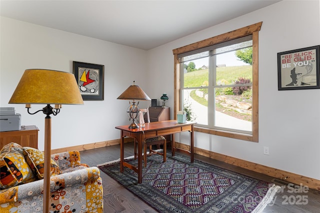 office area with visible vents, baseboards, and wood finished floors