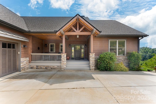 18 Gracie Ln, Weaverville, NC 28787 - entrance to property with stone siding, a porch, and a shingled roof