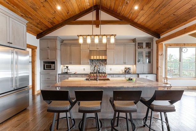 18 Gracie Ln, Weaverville, NC 28787 - kitchen featuring appliances with stainless steel finishes, vaulted ceiling, a kitchen island with sink, dark wood finished floors, and under cabinet range hood
