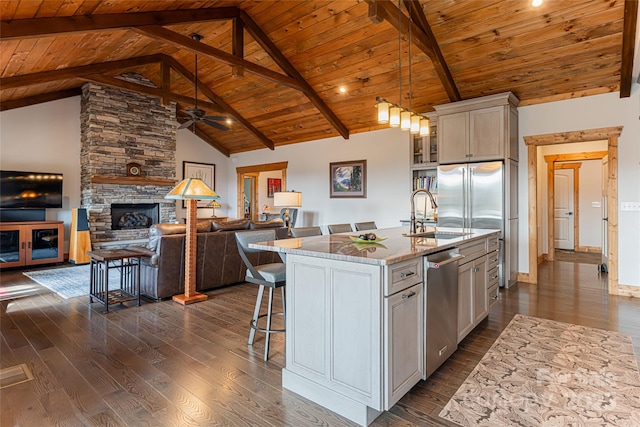 18 Gracie Ln, Weaverville, NC 28787 - kitchen featuring stainless steel appliances, a wooden ceiling with exposed beams, dark wood finished floors, a breakfast bar, and an island with sink