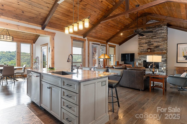 18 Gracie Ln, Weaverville, NC 28787 - kitchen featuring plenty of natural light, dark wood-type flooring, a kitchen breakfast bar, a wood ceiling with exposed beams, and a center island with sink