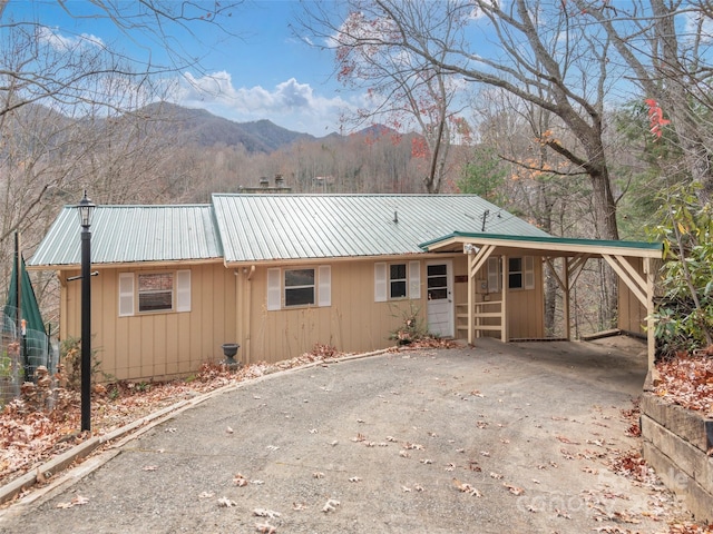 ranch-style house featuring a carport and a mountain view