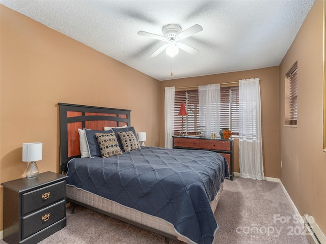 carpeted bedroom with a textured ceiling and ceiling fan