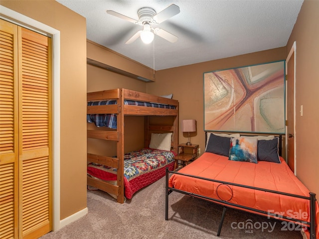 bedroom featuring light colored carpet, ceiling fan, a textured ceiling, and a closet