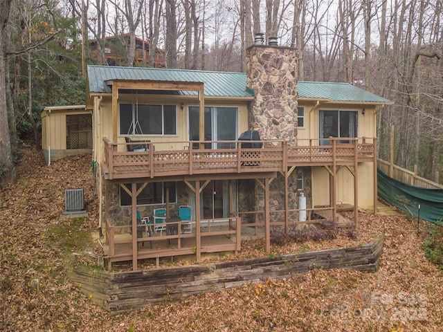 rear view of house featuring a deck