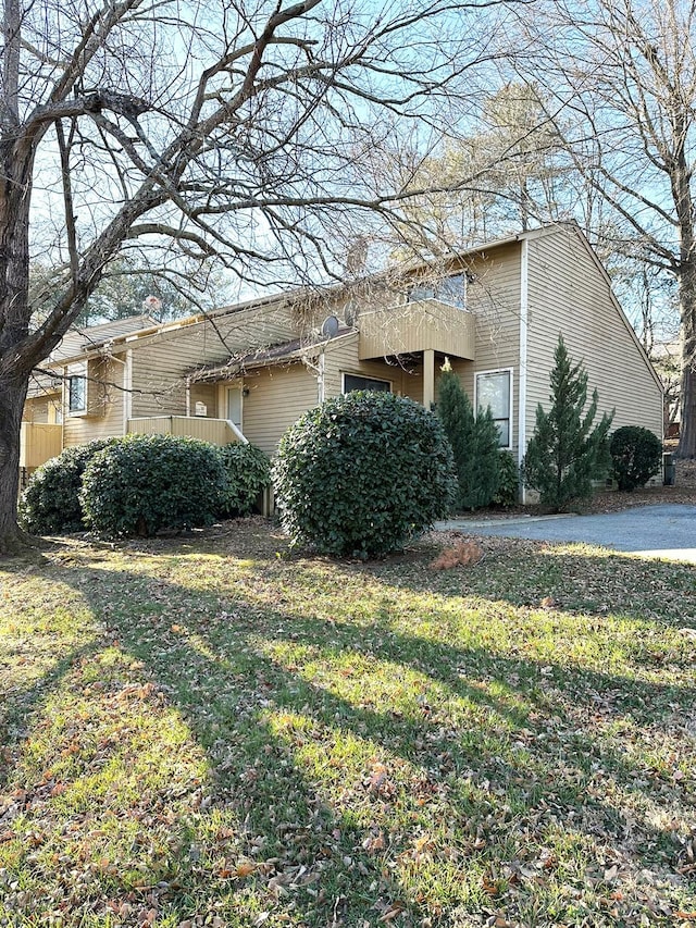 view of side of home with a yard