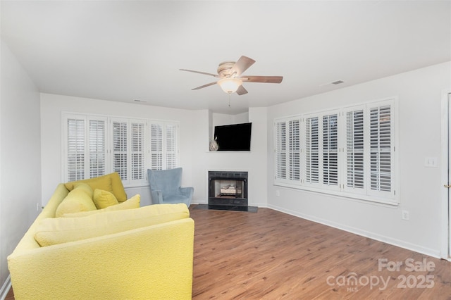 living room with hardwood / wood-style floors and ceiling fan