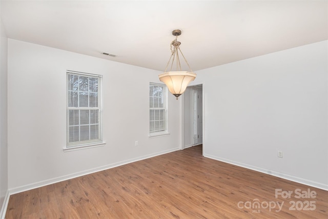 unfurnished room featuring hardwood / wood-style flooring