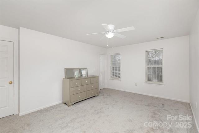 unfurnished bedroom with ceiling fan and light carpet