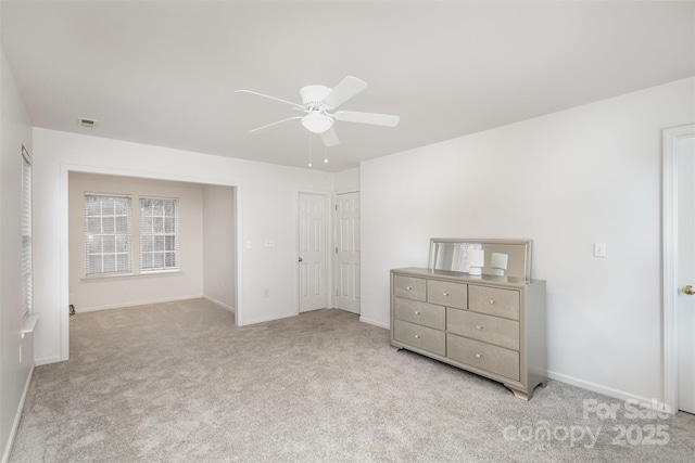 unfurnished bedroom featuring light carpet and ceiling fan