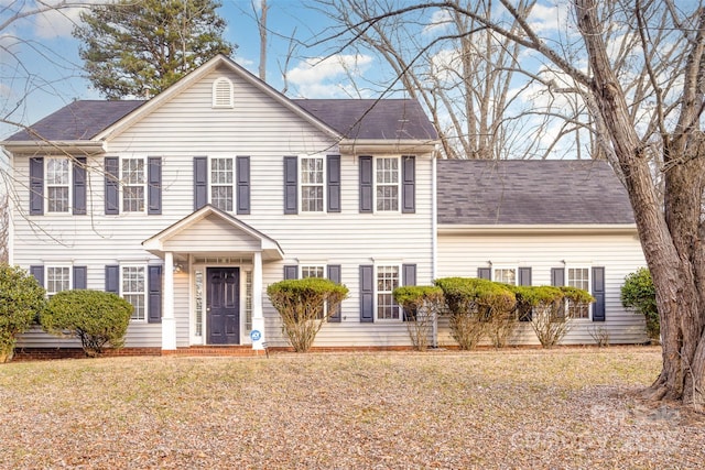 colonial inspired home with a front yard