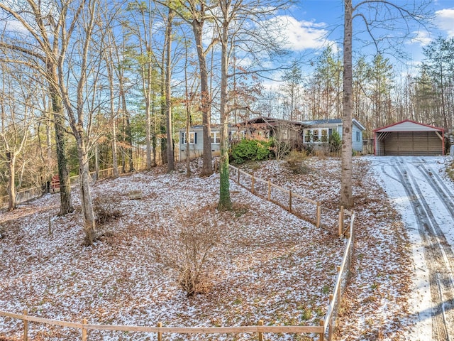 yard covered in snow featuring a carport