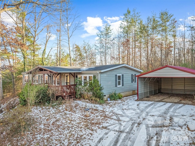 view of front of property featuring a carport and a porch