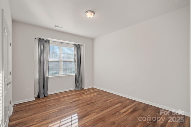 empty room featuring dark hardwood / wood-style floors