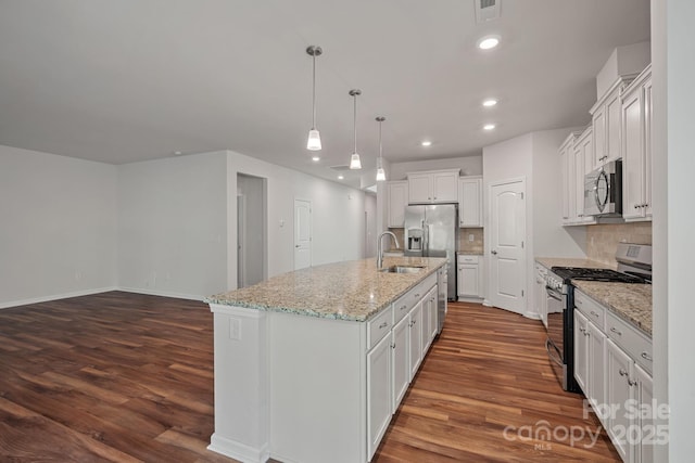 kitchen with appliances with stainless steel finishes, dark hardwood / wood-style floors, an island with sink, sink, and white cabinets