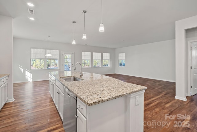 kitchen featuring white cabinetry, sink, hanging light fixtures, a kitchen island with sink, and stainless steel dishwasher