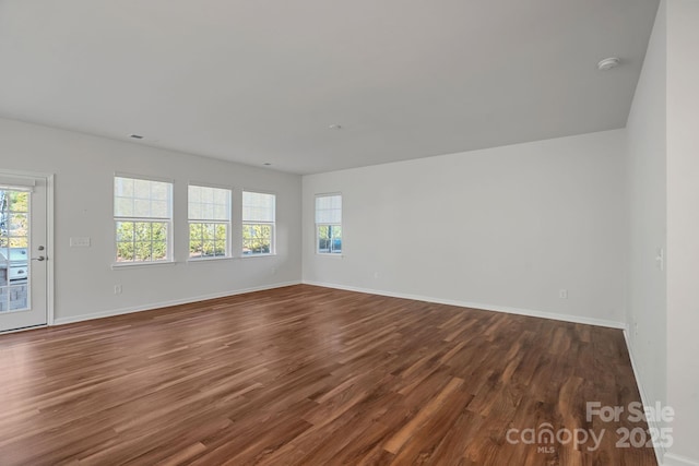 empty room with hardwood / wood-style floors