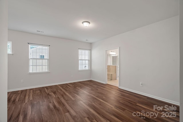 spare room with dark hardwood / wood-style flooring